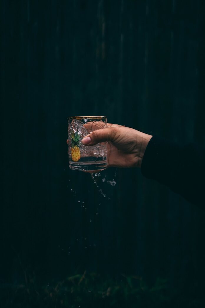 Photo by Hermes Rivera person holding clear drinking glass with water